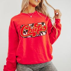 You are going to love this super cute and cozy Kansas City Chiefs Sweatshirt! This is a unisex fit sweatshirt, made with direct to film transfer, no vinyl or sublimation is used.  In order to provide the most color choices, sweatshirts in Pepper, Grey, and Ivory are made using Comfort Colors 100% soft ring-spun cotton, while sweatshirts in white, black, red, and sand are made using Gildan Cozy Feel, 50% cotton 50% poly blend. Both have a ribbed collar and relaxed fit and will make a great addition to your game day wardrobe.  T-shirts are comfort colors soft washed garment-dyed tees, renowned for their softness, comfort, and durability. Made with 100% ring-spun cotton, and sure to make an excellent choice for comfortable daily wear. T-shirts have double needle stitching throughout, sewn in Kc Chiefs Shirts, Chiefs Sweatshirt, Chiefs Shirt, Kc Football, Chiefs Shirts, Kc Chiefs, Womens Sweatshirts, Sweat Shirts, Cozy Fits