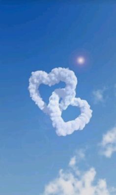 a heart shaped cloud floating in the sky