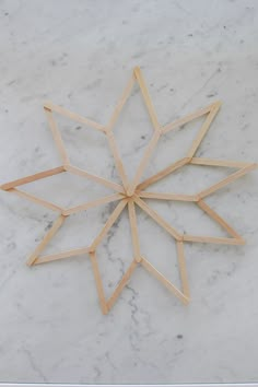 a wooden snowflake sitting on top of a white marble counter