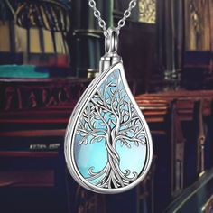 This elegant Tree of Life Teardrop Cremation Necklace combines the powerful symbolism of the Tree of Life with the shape of a teardrop, symbolizing eternal life, immortality, and reincarnation. The necklace is designed to keep the memory of a loved one close to your heart at all times. Design Symbolism: The Tree of Life represents eternal life, growth, and strength, making it a profound symbol of remembrance and continuity. The teardrop shape adds a poignant element, symbolizing love and loss. E Symbolic Teardrop Jewelry For Gifts, Symbolic Teardrop Jewelry Gift, Spiritual Teardrop Necklace For Wedding, Spiritual Teardrop Wedding Necklaces, Silver Drop Necklace With Spiritual Style, Engraved Teardrop Spiritual Jewelry, Silver Engraved Teardrop Jewelry, Teardrop Engraved Necklace For Weddings, Engraved White Gold Teardrop Jewelry