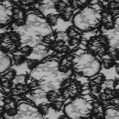 Fall in love with is gorgeous black floral lace fabric perfect for luxurious evening gowns and dresses. In a classic black coloration, this floral lace fabric is filled with a frenzy of roses corded for added textural interest. Laying at 54" in width and completely sheer, let this lace material make a huge impact on your over-all wardrobe or collection in the form of riveting gowns, jackets and overlays. Use this timeless lace fabric and layer it on top of a sateen for a night out on the town or Black Stretch Lace Dress, Black Lace Dress With Lace Trim, Elegant Black Lace Dress With Lace Closure, Party Black Lace With Contrast Detail, Black Scalloped Lace For Party, Black Lace Dress With Lace Patchwork, Black Lace With Lace Trim For Party, Black Lace Dress With Scalloped Lace, Black Delicate Lace Dress