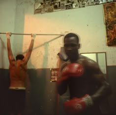 two men with boxing gloves in a bathroom