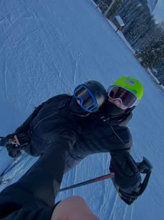 a man riding skis down the side of a snow covered slope