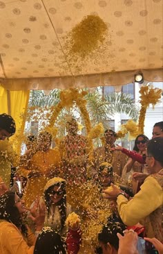 people are throwing confetti on each other at a wedding ceremony in india,