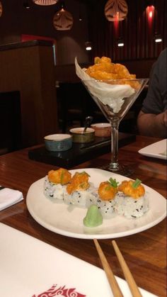 sushi on a plate with chopsticks at a restaurant