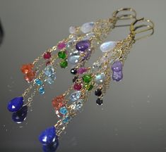 "These Earrings are a beautiful composition of Stunning Gemstones that are presented to You in a \"Rainbow\" of Colors: It will bring a smile to your recipient's face and it sure to go with any outfit! Each Earring features 14 Unique Gemstones in a variety of shapes and sizes. This gives the earrings lots of character and each gemstone is individually hand wired for a more bohemian look and feel. >Rainbow, Rainbow Statement Earrings, Chain Drop Earrings, Gemstone Earrings, Duster Earrings, Lo Fine Jewelry Multi-stone Drop Earrings, Elegant Multi-stone Long Drop Jewelry, Elegant Long Drop Multi-stone Jewelry, Elegant Multi-stone 14k Gold Earrings, Elegant Multi-stone Drop Jewelry, Multi-stone Drop Earrings In Fusion Style, Fusion Multi-stone Drop Earrings, Fusion Style Multi-stone Drop Earrings, Elegant Multi-stone Drop Gemstones