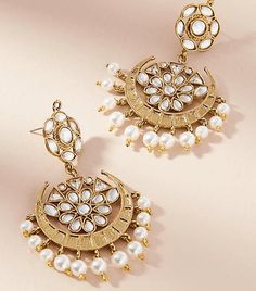 Love India by Blossom Box's Starburst Pearly Earrings comes in a gold plated finish with stunning polki stones & pearls to make these exquisite earrings really special - this pair are light in weight & can be paired with almost any outfit. Perfect accessory for every jewelry box! Handcrafted Metal: Metal Alloy, Gold Plated Stone: Polki Stones & Pearls Size: Length: 2.5" Width: 2.75" Closure: Post for Pieced Ears Affordable Traditional Festive Earrings, Luxury Round Earrings For Diwali, Luxury Traditional Pearl Earrings For Festivals, Luxury Pearl Earrings For Diwali Gift, Luxury Pearl Earrings With Intricate Design For Diwali, Luxury Festive Meenakari Pearl Earrings, Glamorous Pearl Drop Jewelry As Gift, Glamorous Pearl Drop Jewelry For Gift, Pearl Drop Dangle Chandbalis Gift