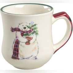 a white mug with a bear holding a christmas tree