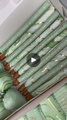 some green and white vases sitting in a box