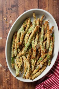 fried green beans in a white bowl on a wooden table