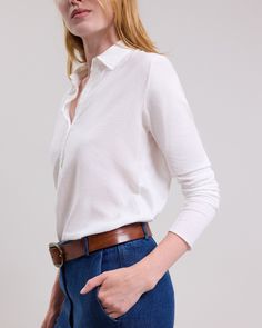 Women's long-sleeved polo tee shirt. Shirt collar and half button placket. Timeless Button-up Tops With Placket, Classic Long Sleeve Henley With Ribbed Collar, Timeless Long Sleeve Fall Tops, Timeless Collared Tops For Fall, Timeless Cotton Tops With Placket, Timeless Long Sleeve Tops With Buttons, Long Sleeve Polo Sweater With Button Cuffs For Work, Classic Johnny Collar Tops For Work, Timeless Collared Tops With Buttons