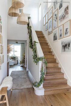 the stairs are decorated with greenery and pictures