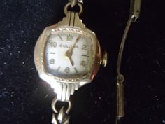 Vintage Lady Bulova, Art Deco in design.   Marked 10k Rolled Gold Plate and numbered; 8117011.  It has a clasp closure that reads: 1/20-12k G. F. Sterling base Pat.2.097.055 USA.  Winding mechanism needs repair.  Includes original which reads: Bulova, Fifth Avenue - New York.  The Goddess of Time. Item# J0171 Goddess Of Time, Vintage Lady, Plate Art, The Goddess, Wrist Watches, In Design, Womens Watches, Wrist Watch, Vintage Ladies