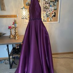 A Long Purple Dress With A Beautiful Opened Back! Elegant Purple A-line Maxi Dress, Elegant Purple A-line Gown, Purple Dress With Fitted Bodice For Homecoming, Elegant A-line Homecoming Gown, Purple A-line Evening Dress For Formal Occasions, Purple Satin Formal Dress, Elegant A-line Purple Maxi Dress, Purple Floor-length Dress For Homecoming, Elegant Purple Evening Dress For Homecoming