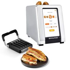 a sandwich maker and plate with two sandwiches on it