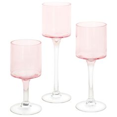 three pink wine glasses sitting next to each other