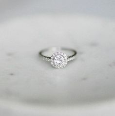 a diamond ring sitting on top of a white plate