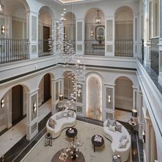 a large living room with high ceilings and chandeliers