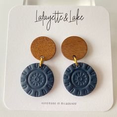 Handmade polymer clay wooden stud with navy circle medallion earrings--perfect for work and play! The wood circle stud measures half an inch and the entire earring is 1.4 inches. At it's widest, the earrings are .75 inches.  Each pair of earrings is one-of-a-kind, made by me, so any slight imperfections or variances make them unique. There also could be small air bubbles, scratches, and may slightly differ from the picture you see here. Polymer clay is lightweight, durable and can last a long time with proper care: * Remove before showering, swimming, exercising, and bedtime * Allow lotions and perfumes to dry before wearing * Store away from direct sunlight * To clean your earrings use a damp cloth and wipe gently. I do not offer refunds or exchanges due to hygiene reasons. Please notify Medallion Earrings, Wear Store, Wood Circles, Circle Studs, Air Bubbles, Heart Studs, Etsy Earrings Dangle, Heart Earrings Studs, Circle Earrings