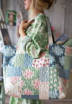 a woman carrying a quilted tote bag