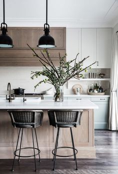 a kitchen with two stools and an island