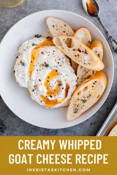 creamy whipped goat cheese recipe on a white plate with bread and wine in the background