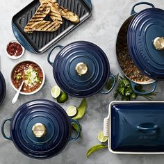 blue pots and pans with food on them