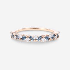 a rose gold ring with blue and white stones