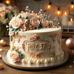 a white cake with flowers on it sitting on top of a table