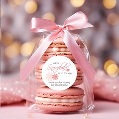 a pink macaroon with a ribbon tied around it's neck and label that says, thank you for being our special day