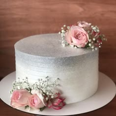 a white cake with pink flowers on top