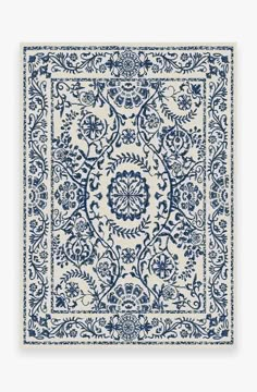 a blue and white rug with an intricate design on the bottom, in front of a white background