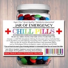 jar filled with jelly beans on top of a wooden table next to a sign that says jar of emergency