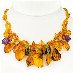 Bozena Przytocka is a designer of artistic amber jewelry based in Gdansk, Poland. Here is a beautiful example of her ability to blend amber, amethyst and peridot to create a stunning necklace. Luxury Handmade Amber Necklace, Collectible Amber Necklace With Natural Stones, Amethyst And Peridot, Polish Christmas, Military Pins, Gdansk Poland, Polish Stoneware, Gold Eagle, Polish Art