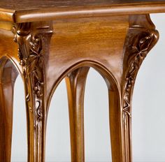 an ornately carved wooden table with two legs