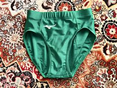 a pair of green panties laying on top of a rug