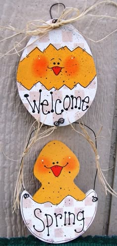 two wooden signs that say welcome and spring