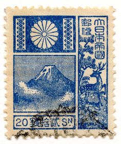 an old stamp with the image of mount fuji on it's front and side