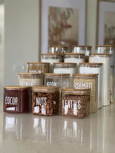 several jars filled with nuts sitting on top of a counter