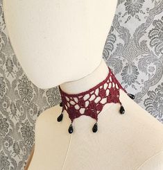 Here is a beautiful deep raspberry beaded choker, crocheted out of 100% cotton thread. There are glass faceted black beads along the lower edge.  The choker itself measures approximately 12 1/2" around the neck by about 3 1/2" from top to bottom edge. It closes in back with a chain and lobster clasp that can add up to 2".   It has been lightly starched using a non-aerosol, biodegradable starch. If the choker needs to be laundered, hand wash gently in cold water and mild soap, and lay out to dry, stretching out to original shape. This design was created, developed and handmade by Scarlet Rabbit and is under copyright. Please do not duplicate. This was made in a smoke free but not pet free home.  If you are interested in making this yourself, the crochet pattern is available in the shop! Enj Crochet Choker Free Pattern, Steampunk Choker, Vampire Jewelry, Victorian Choker, Victorian Collar, Crochet Choker, Gothic Chokers, Vintage Goth, Goth Jewelry