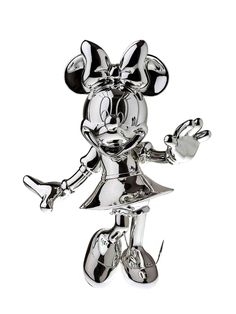 a silver mickey mouse figurine is shown on a white background and has one hand in the air