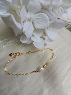 A gorgeous and dainty pearl bracelet.   A classic fresh water pearl sits between tiny gold plated beads, attached to a shiny gold plated over sterling silver (excellent quality) chain. Fits most women's wrist with a length starting at  6.5 and extender going up to 7.5". Dainty Yellow Gold Beaded Bracelets In 14k Gold Filled, Handmade Elegant Gold-plated Beaded Bracelets, Gold Bracelet With Pearl Charm, 14k Gold Filled, Handmade Gold-plated Elegant Beaded Bracelet, Elegant Handmade Gold-plated Beaded Bracelets, Elegant Handmade Gold-plated Beaded Bracelet, Dainty Pearl Charm Beaded Bracelets, Dainty Beaded Pearl Bracelets With Charm, 14k Gold-filled Pearl Bracelet With Gold Beads