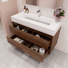 a bathroom vanity with drawers and a sink