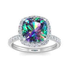 This mystic topaz ring features one 10mm cushion cut mystic topaz gemstone. It is surrounded by 38 sparkling diamonds totaling 1/2 carat in I-J color, I1-I2 clarity. Total carat weight is approximately 5 1/2 carats. This ring is in sterling silver. Size: 5.5.  Color: Purple.  Gender: female.  Age Group: adult.