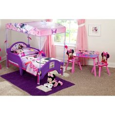 a child's bedroom with minnie mouse furniture and accessories