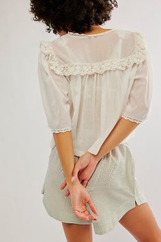 Effortlessly femme and so sweet, this billowy blouse is featured in a soft cotton fabrication and slightly cropped fit with delicate lace trim and puff-inspired sleeve detail. **Fit:** Relaxed fit, slightly cropped **Features:** Soft cotton fabrication with a lightweight feel, deep V-neckline, button-front closures, embroidered detail throughout, lace trim, puff-inspired short-sleeves **Why We ❤ It:** This versatile top can be dressed up or down for any outing. | Luna Top by Free People in White Peter Pan Collar Pattern, Billowy Blouse, Streetwear Blouse, Loose Dress Pattern, Lace Shirts, Short Sleeve Blouses, Romper Suit, Chic Tops, Women Blouse