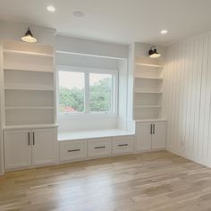 the empty room is clean and ready to be used as a living area with built - in bookshelves