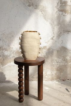 a vase sitting on top of a wooden table