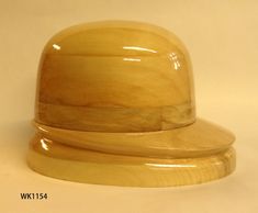 a wooden hat sitting on top of a white table