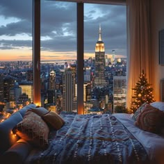 a bedroom with a view of the empire building and christmas tree in the foreground